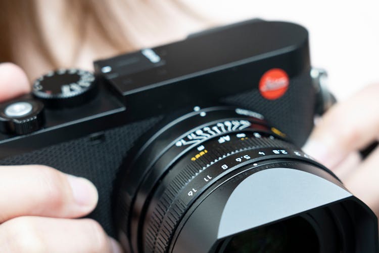 Close-up Of Woman Holding A Leica Digital Camera 