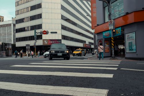 Free Urban intersection with pedestrians and traffic in a bustling city environment. Stock Photo