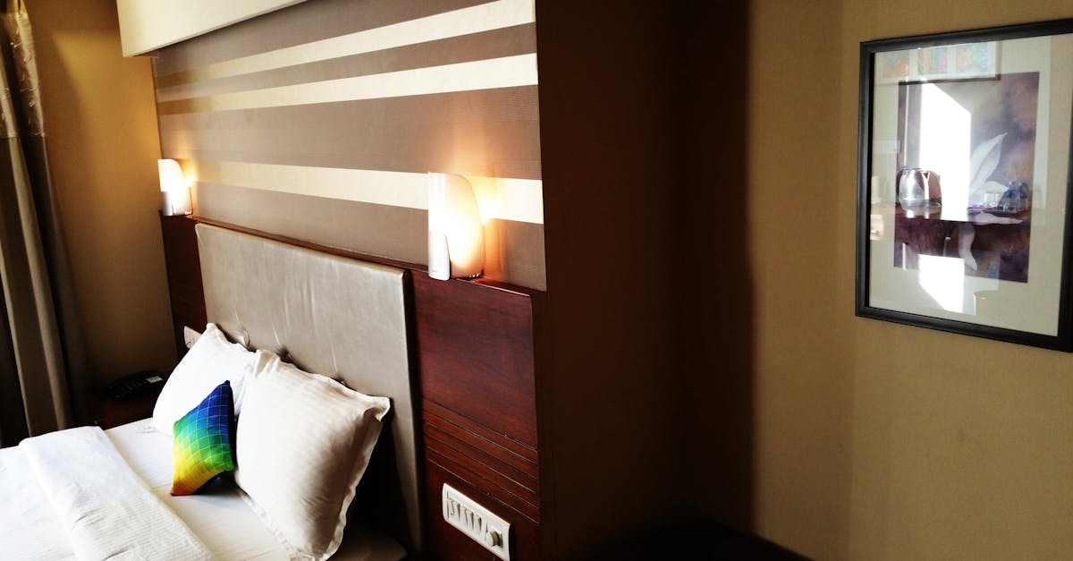Empty Bed With Wooden Headboard and Lamps