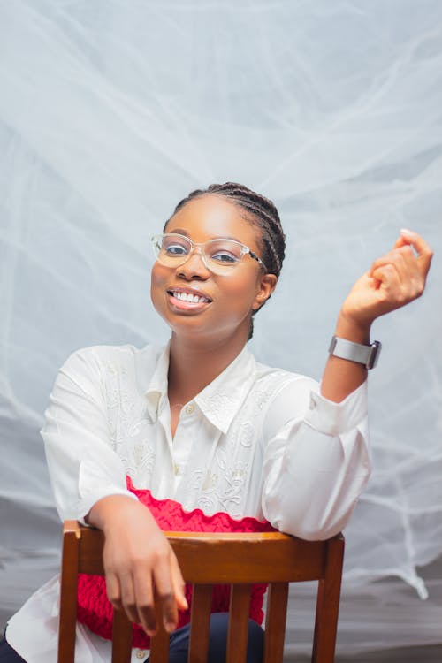 Smiling Woman in Eyeglasses Sitting