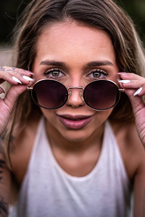 Woman Looking over Glasses