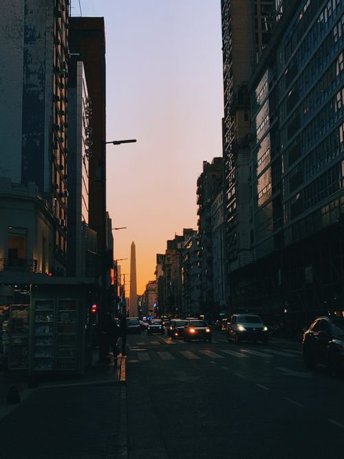 Free Downtown Buenos Aires street scene at sunset, highlighting urban life and city skyline. Stock Photo