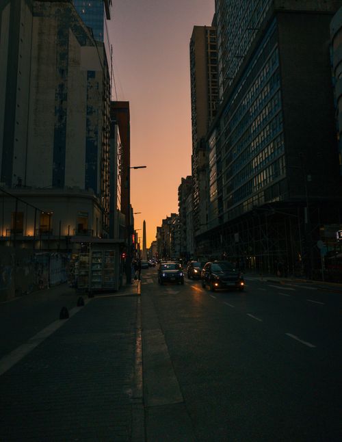Free Urban street view of Buenos Aires at dusk with skyscrapers and cars. Stock Photo