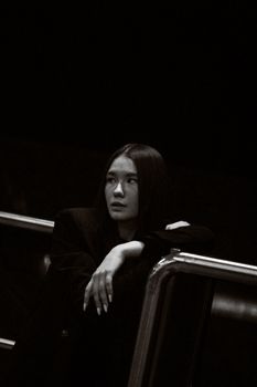Thoughtful woman in monochrome setting, evoking introspection and quiet strength.