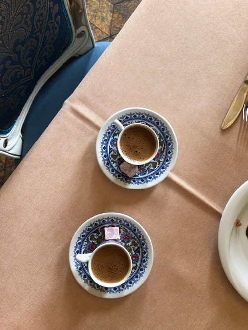 Free A top view of two beautifully decorated Turkish coffee cups with Turkish delight on a table. Stock Photo