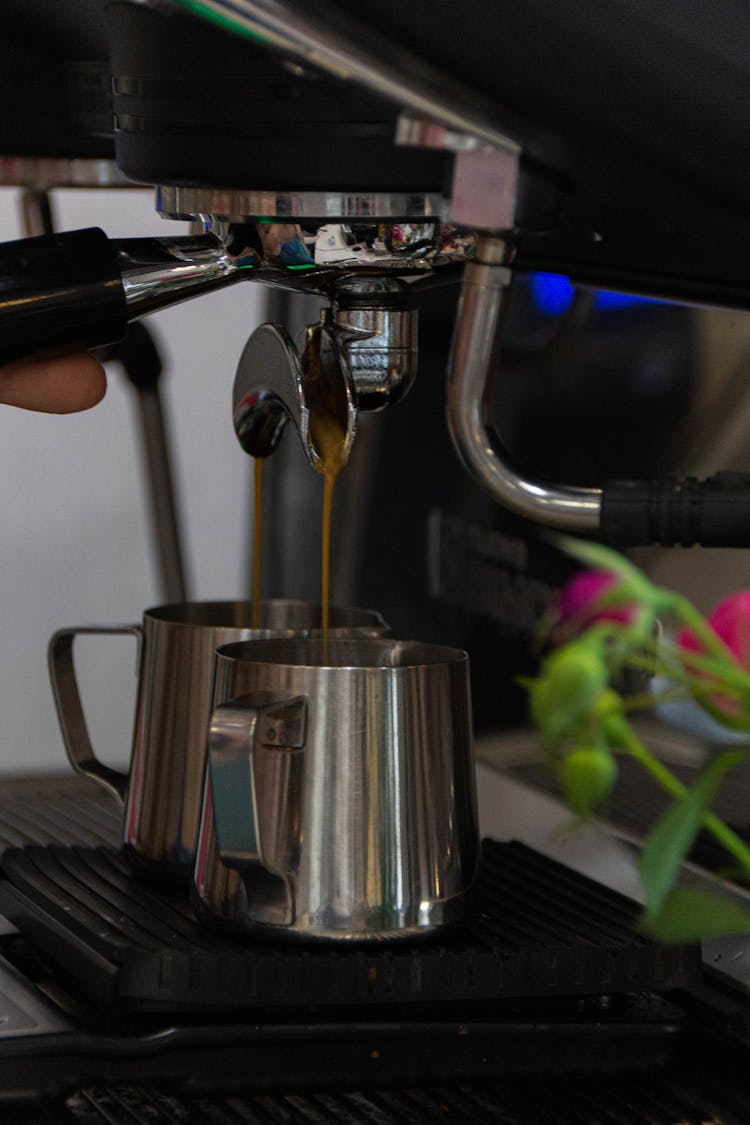 Coffee Machine Pouring Coffee To Kettles