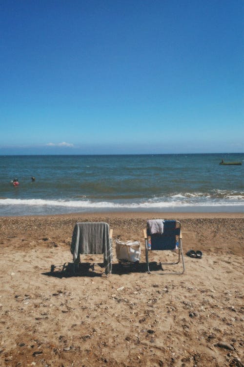 Chairs on Sunlit Beach