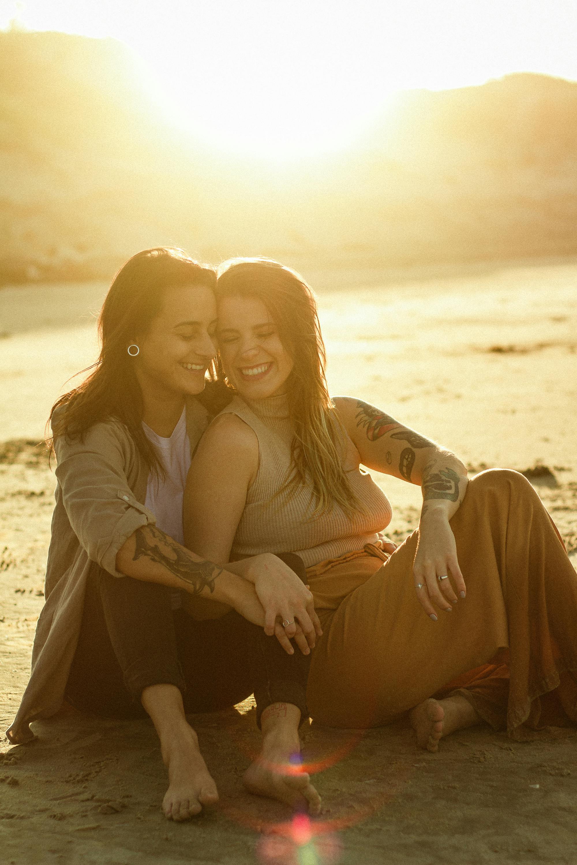 couple friends on beach together walking during sunset Stock Photo by  Igor_Kardasov