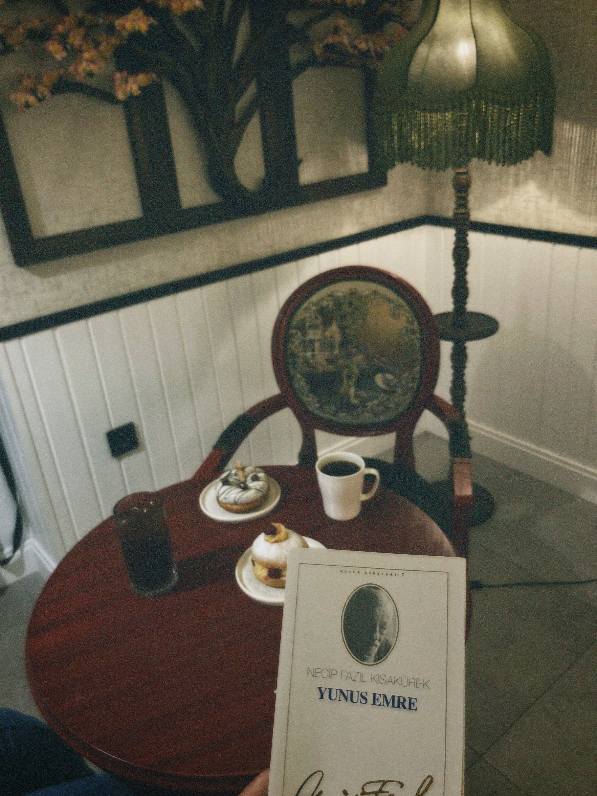 A vintage café setting with a chair, table, and snacks, evoking a retro ambiance.