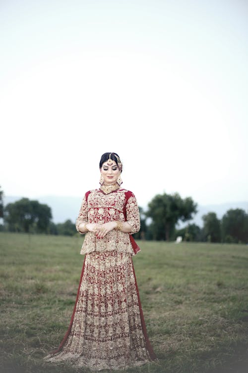 Woman in Traditional Dress on Grassland