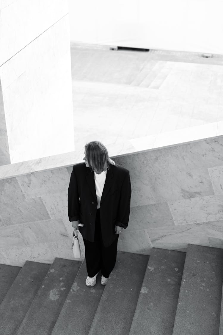 Woman In Suit Posing On Stairs 