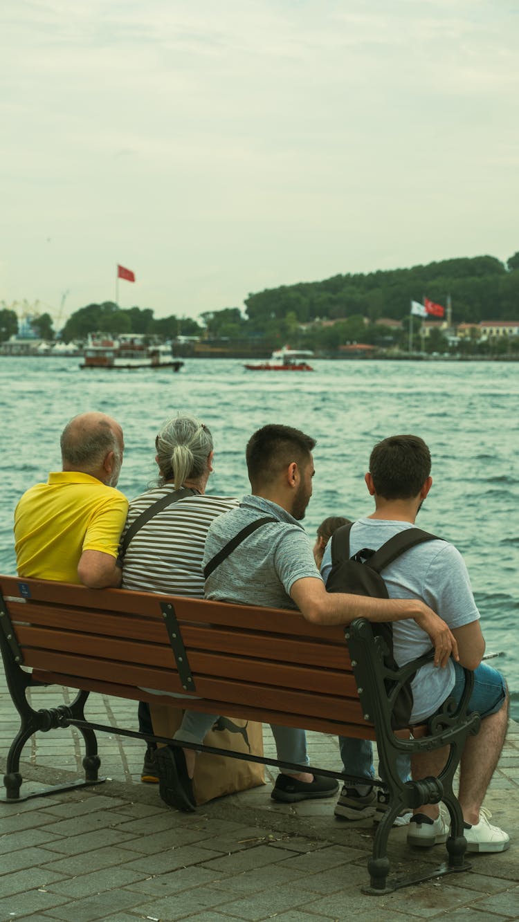 People Sitting On Bench On Sea Shore In Turkey