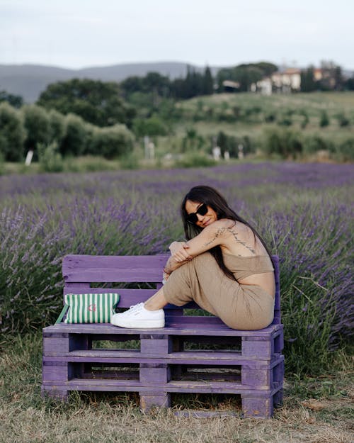 Woman Posing on Purple Bench near Lavender Field