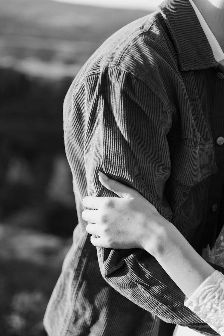 Woman Hand On Man Shirt In Black And White