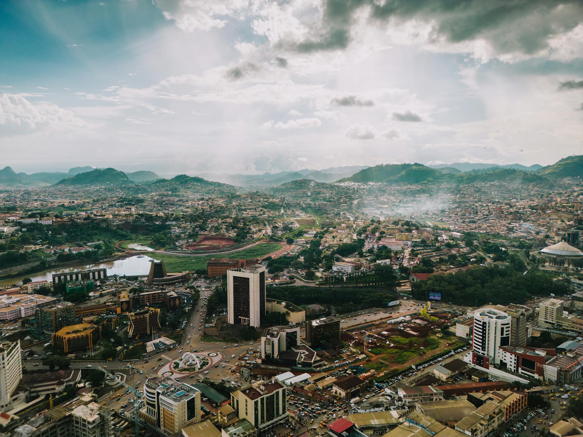 A captivating aerial view of the sprawling cityscape of Yaoundé, Cameroon, under a dramatic sky.