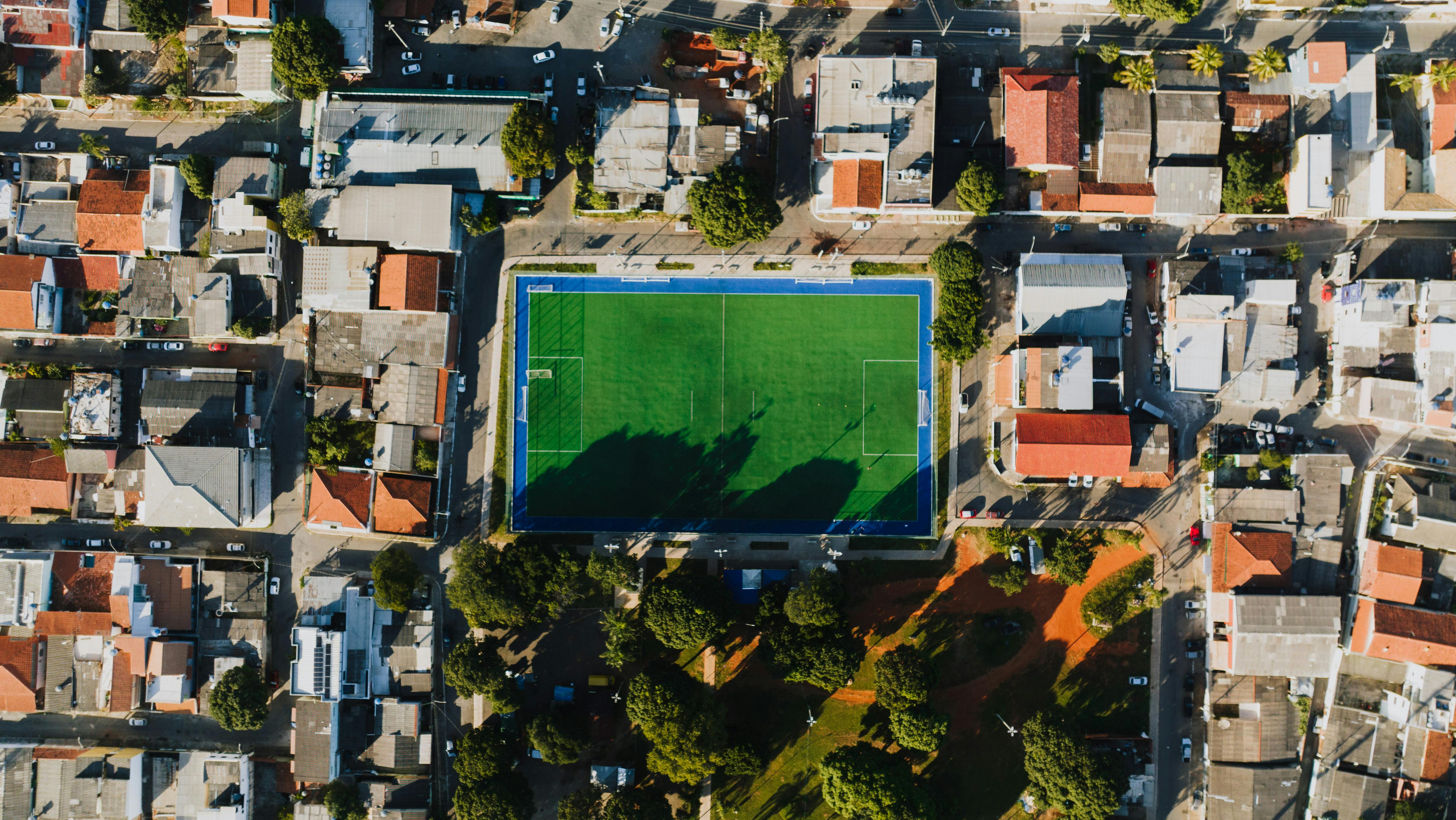Drone shot of a soccer field in Vila Planalto, DF, Brazil surrounded by residential area.