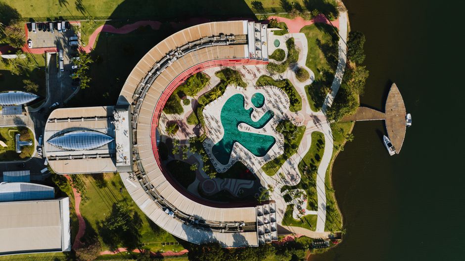 Unforgettable Family Pack Day/After-hours 31 Miles Helicopter Tour Theme Parks Review 2026 - A stunning aerial shot of modern architecture and a unique pool in Brasília, Brazil.