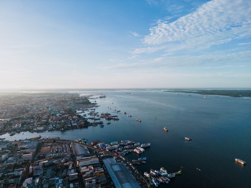 Stunning aerial shot of Manaus harbor along Rio Negro with ships and cityscape under a clear sky