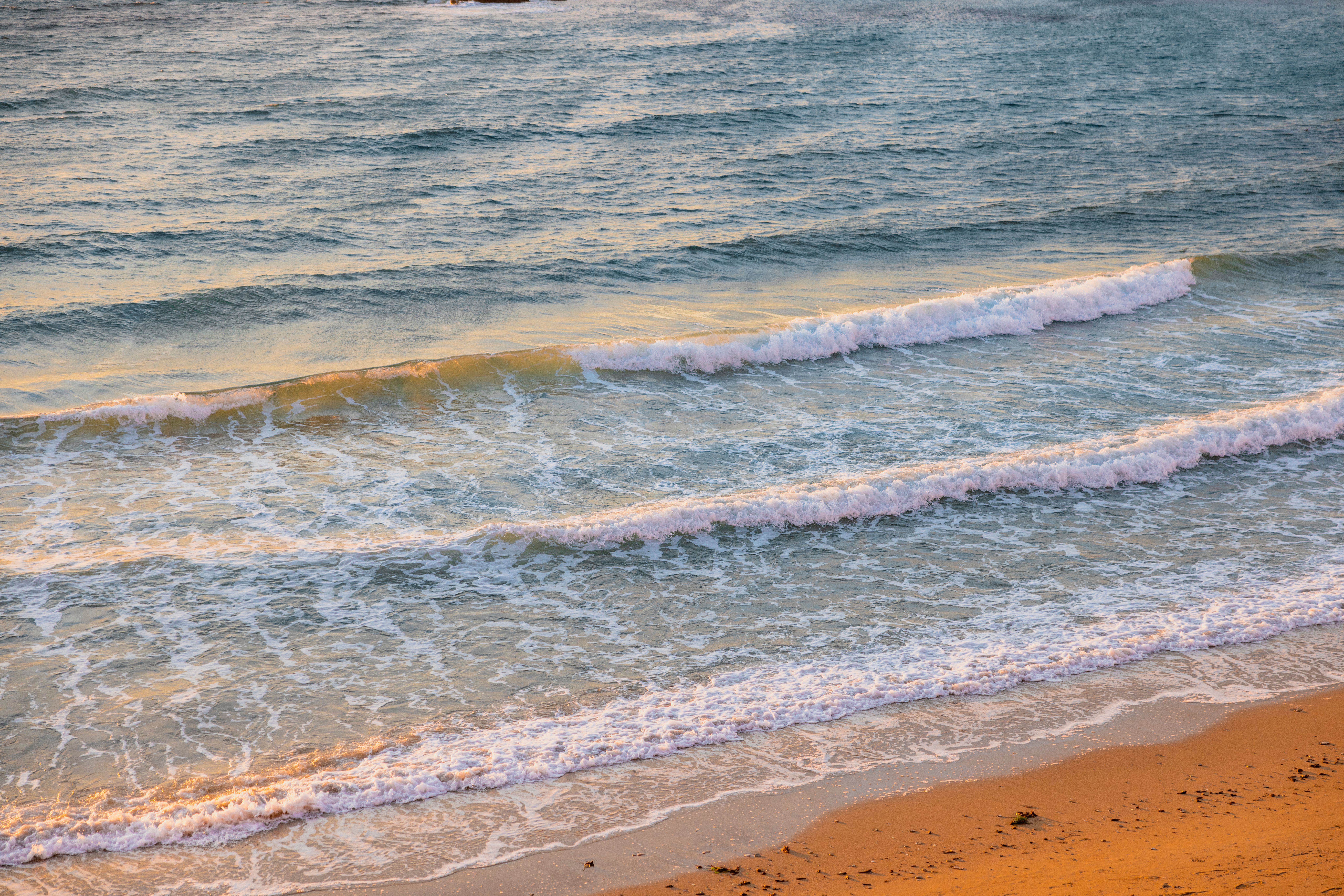 Beautiful waves and golden sand along Gallipoli's coast, captured during a serene sunset.