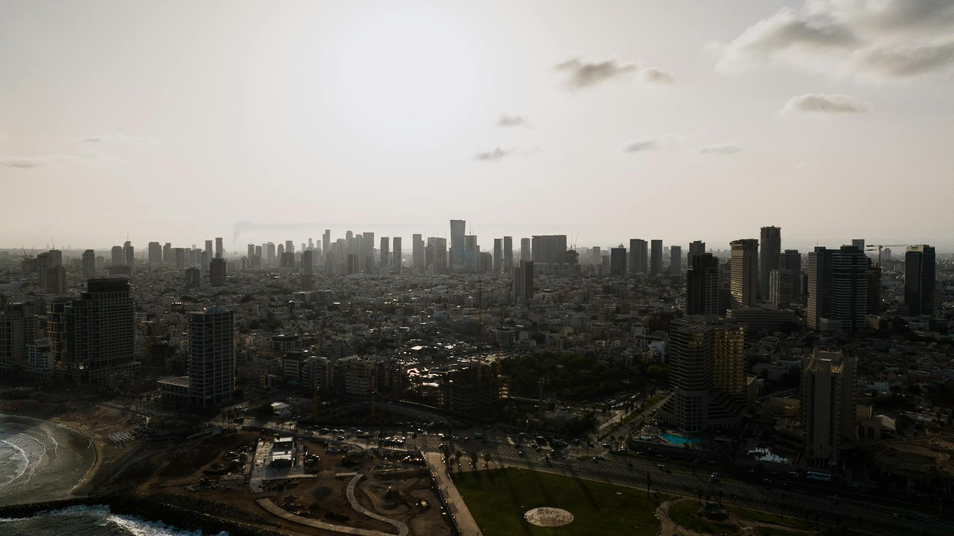 Discover the vibrant skyline of Tel Aviv with its modern skyscrapers silhouetted against the sunset.