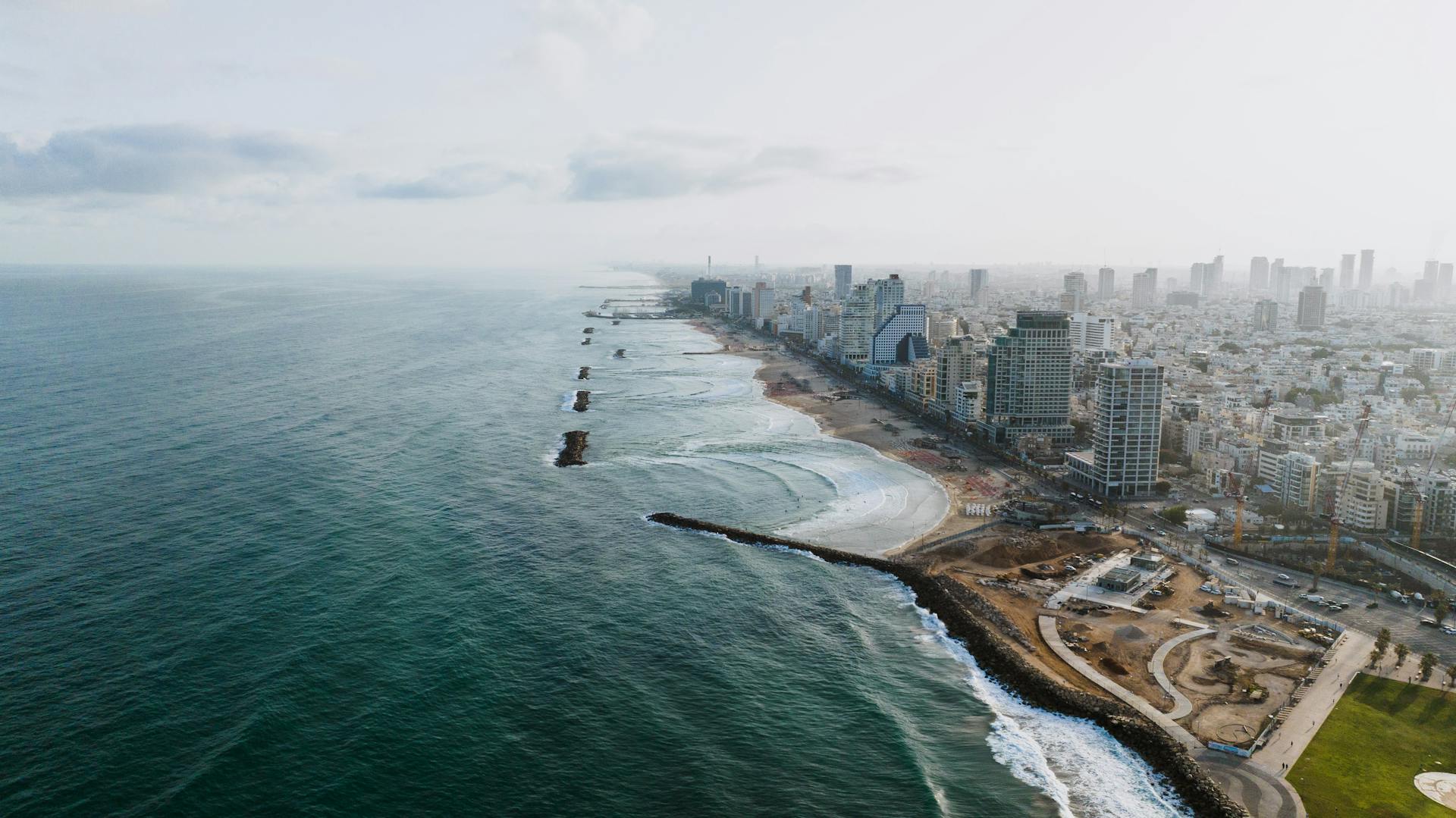 Stunning aerial view of Tel Aviv skyline and beach, showcasing vibrant city and coastline.