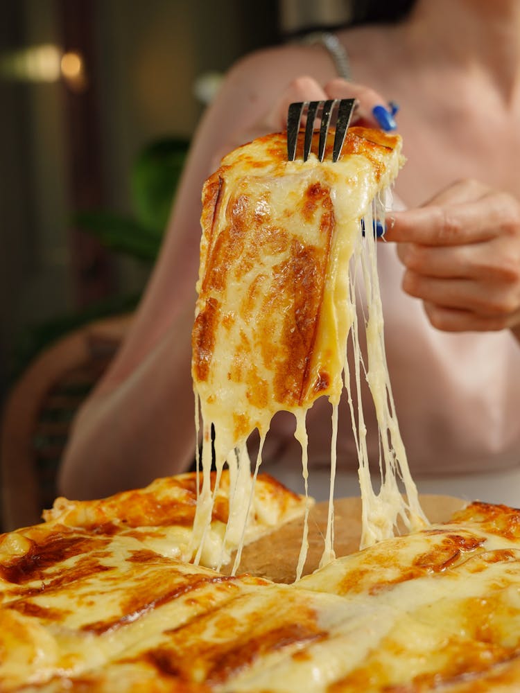 Close-up Of Woman Eating Pizza