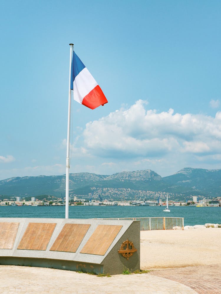 French Flag On Square Near Water