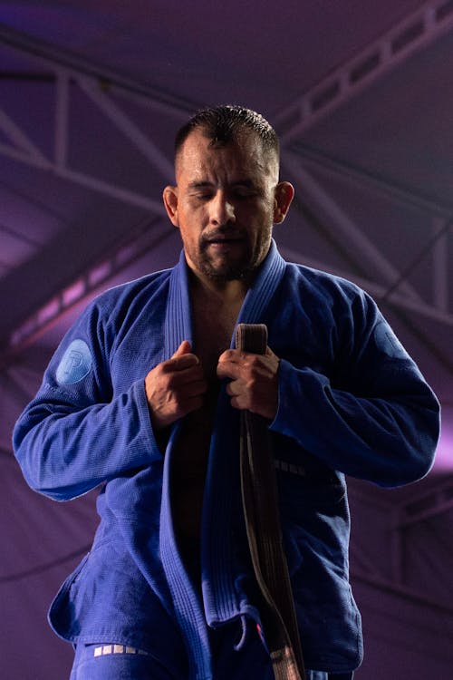 Free Man in Blue Kimono Holding a Black Belt Stock Photo