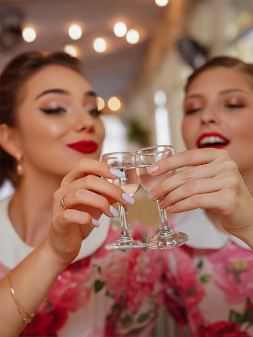Women Holding Glasses with Alcohol