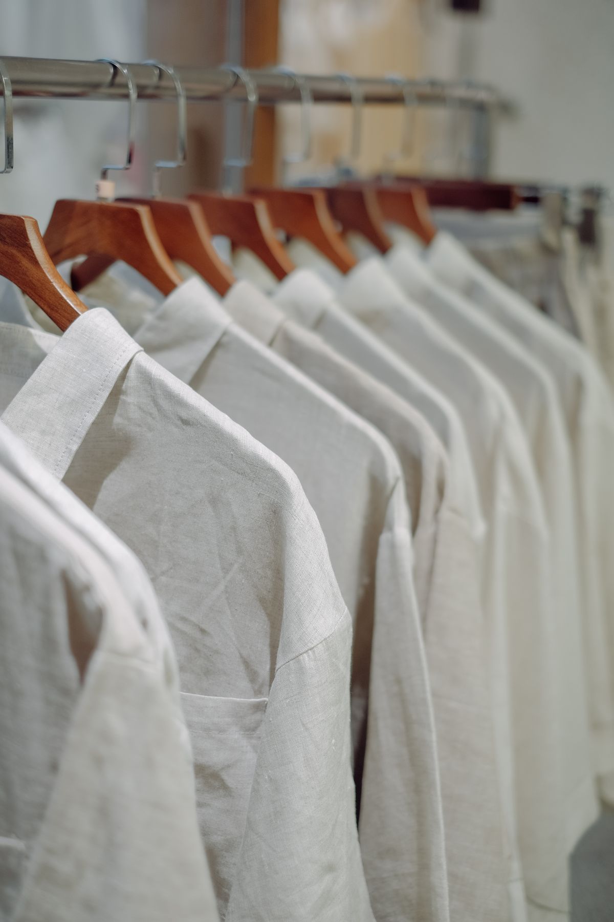 Pressed white shirts hanging in a quiet interior