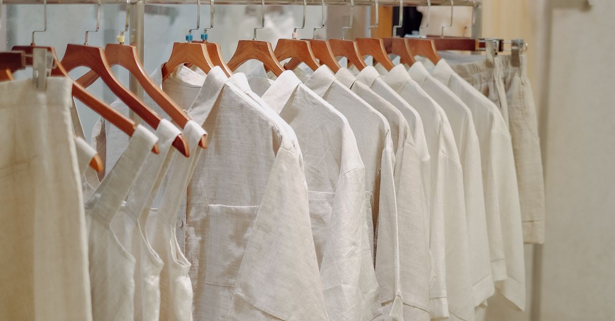 Clothes in Neutral Colors Hanging on the Racks in a Clothing Store ...