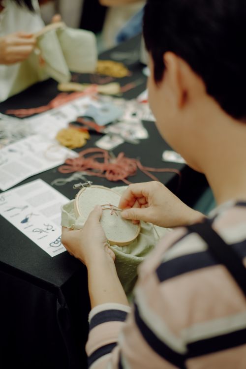 Free Focused view of a person engaged in hand embroidery, capturing the art of crafting with detail and creativity. Stock Photo