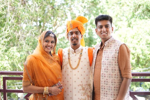 Woman Posing with Men in Traditional Clothing