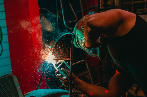 Free A welder skillfully works with sparks flying, captured in a Lima workshop. Stock Photo
