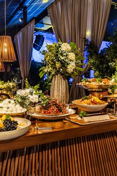 A beautifully arranged buffet table with floral decor in a restaurant setting.