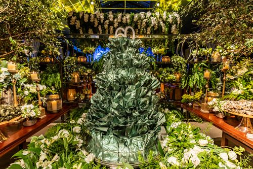 Free Opulent floral and candle arrangement for a 60th birthday party, emphasizing abundant greenery. Stock Photo