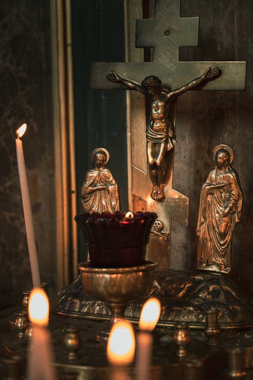 Candle and Metal Crucifixion on Altar