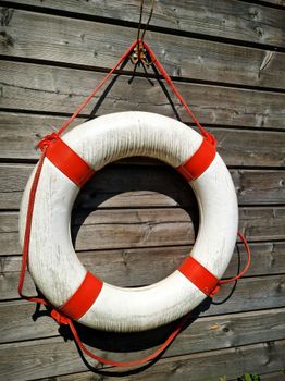 Close-up of a lifebuoy hanging on a wooden wall in Kvinnherad, Norway.