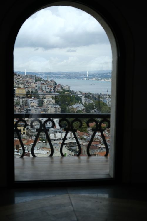 Free Captivating view of Istanbul's cityscape through an elegant arched window overlooking the Bosphorus. Stock Photo