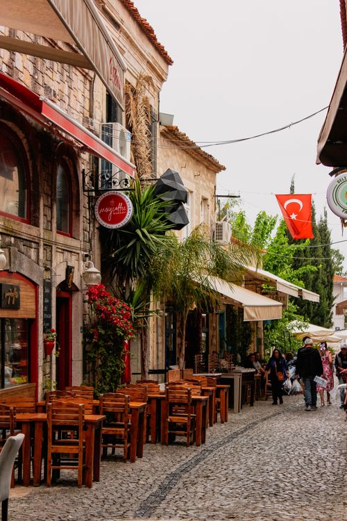 Free Explore the quaint cobblestone streets of Alaçatı, İzmir, lined with cafes and shops. Stock Photo