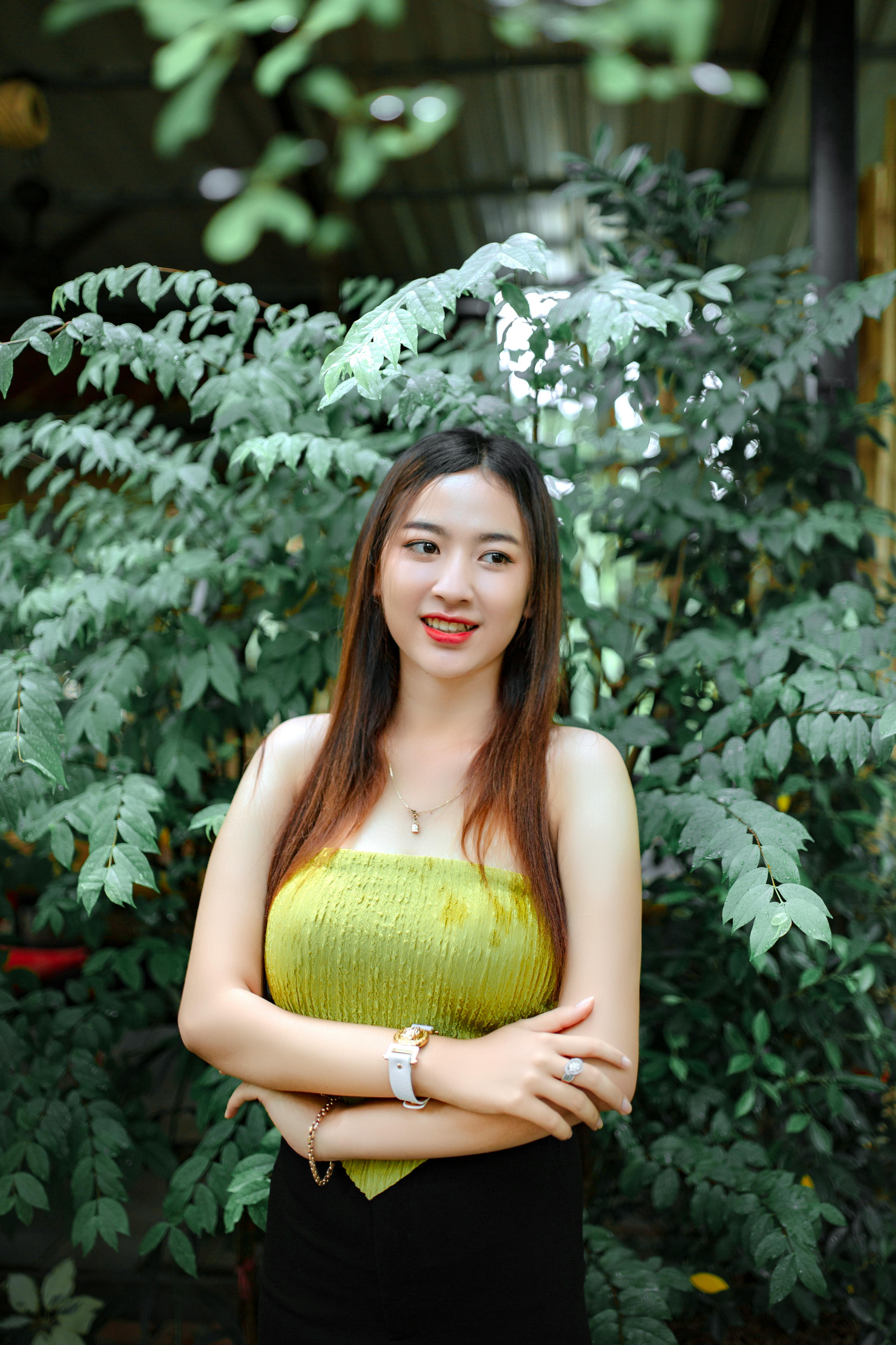 Cute Brunette Woman in Green Blouse Posing in Garden · Free Stock Photo