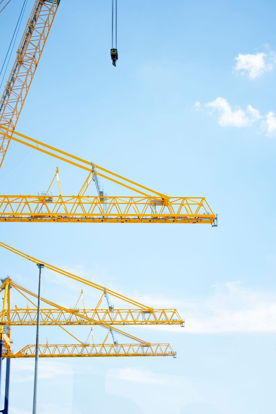 Construction cranes against an open sky