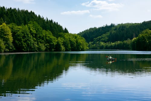 Person Kayaking on Lake in Luxembourg