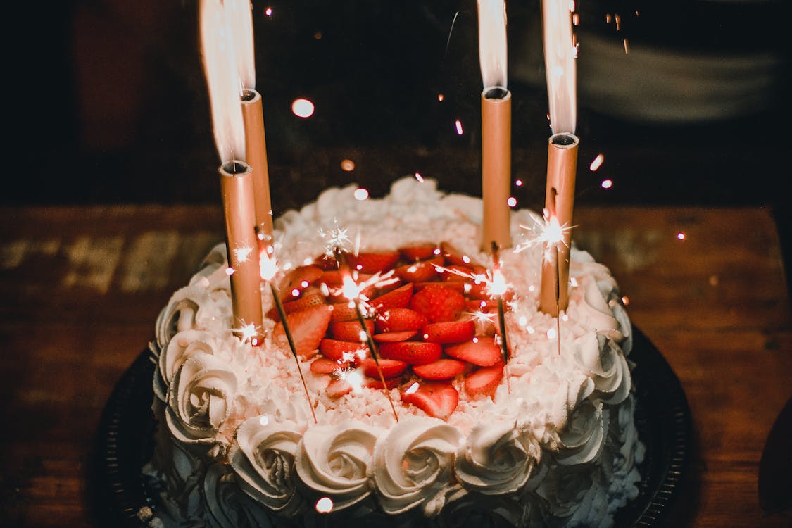 Free Lighted Candles on an Elegant Looking Cake  Stock Photo