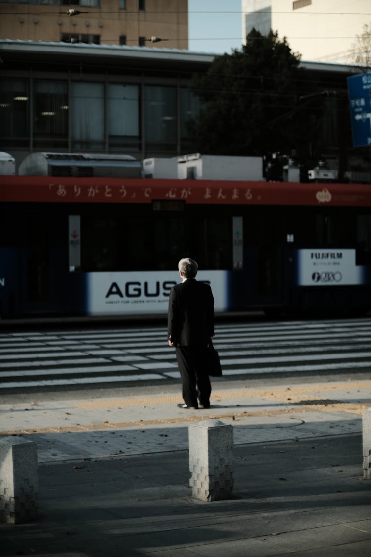 Man In Suit Waiting At Crosswalk