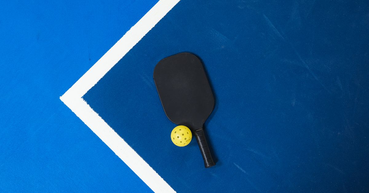 Aerial view of colorful pickleball lines painted over an old tennis court in a neighborhood park