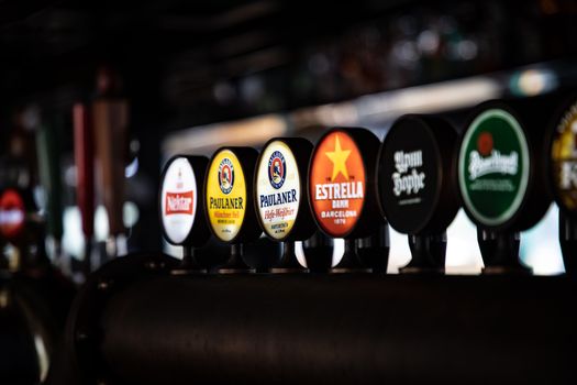Row of Beer Labels in a Bar