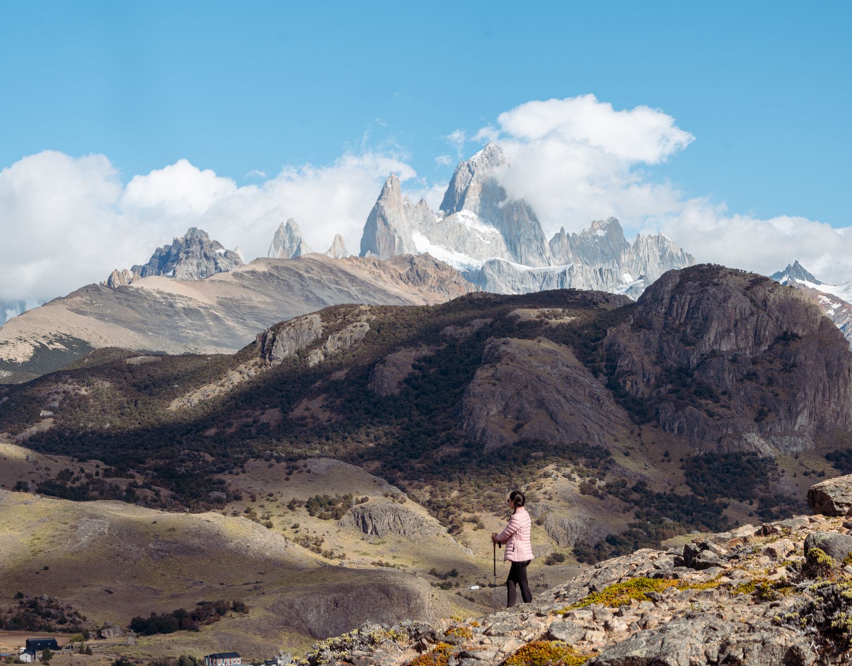 A lone hiker crossing alpine mountain terrain in Argentina