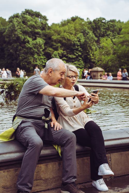 Senior Couple Taking Photo with a Smartphone by a Pond in a Park · Free ...