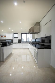 Discover a luxurious modern kitchen with sleek cabinetry and polished surfaces.